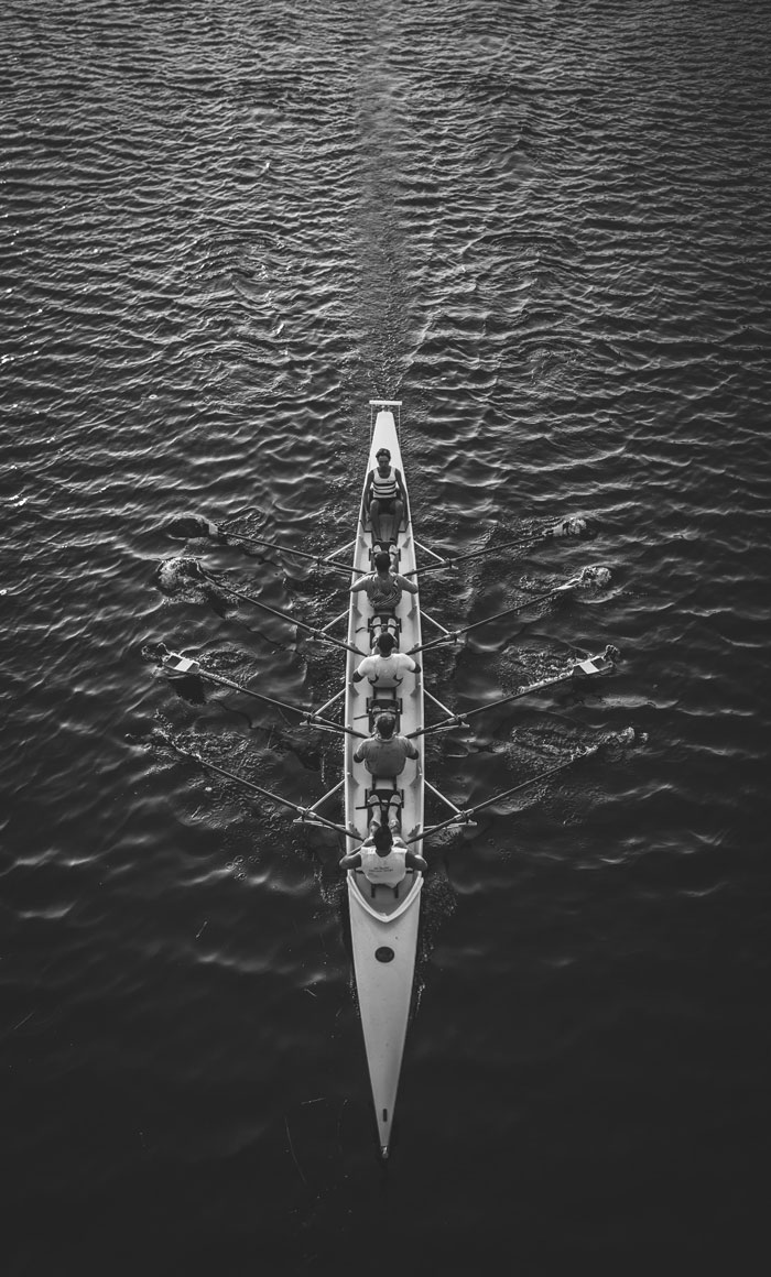 Rowing team working together on the water